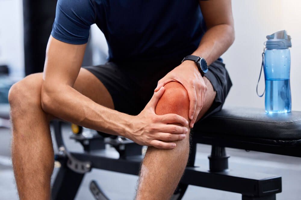 man and knee pain in gym