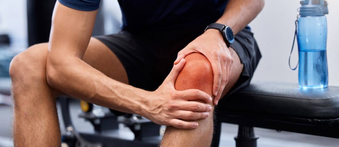 man and knee pain in gym