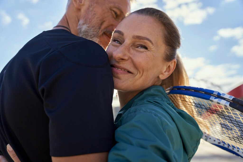 Portrait of active mature couple looking happy while embracing each other