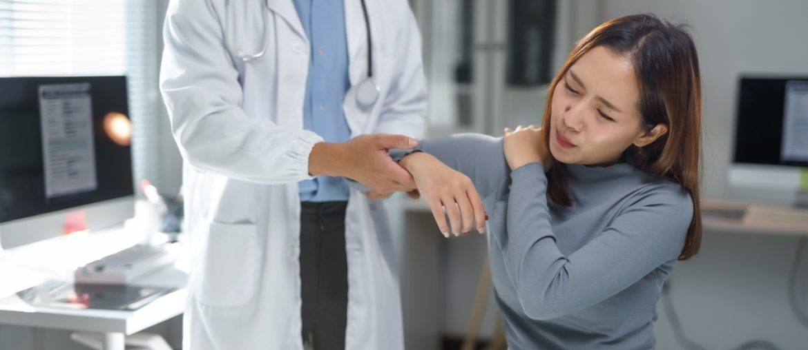 Doctor,Examining,The,Arm,Of,A,Young,Woman,Experiencing,Shoulder