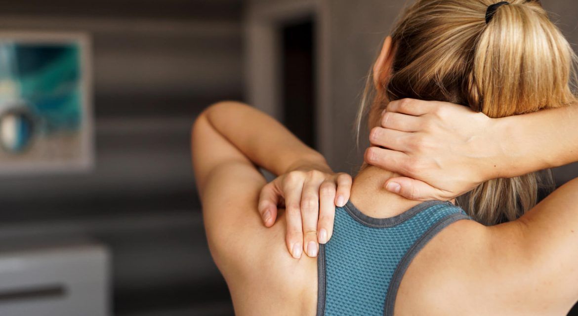 Athletic woman feeling pain in her neck