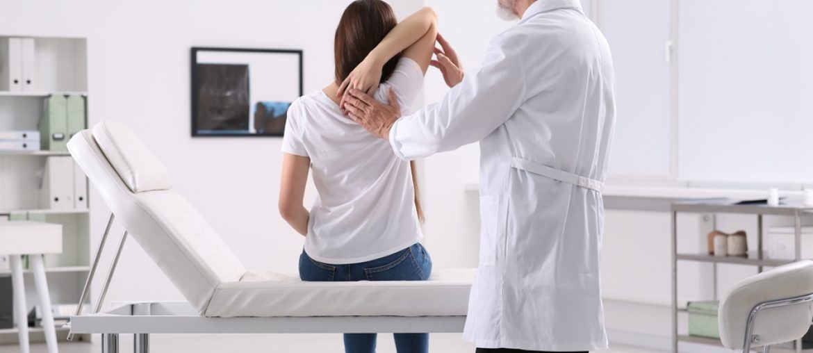 Professional,Orthopedist,Examining,Patient's,Shoulder,In,Clinic