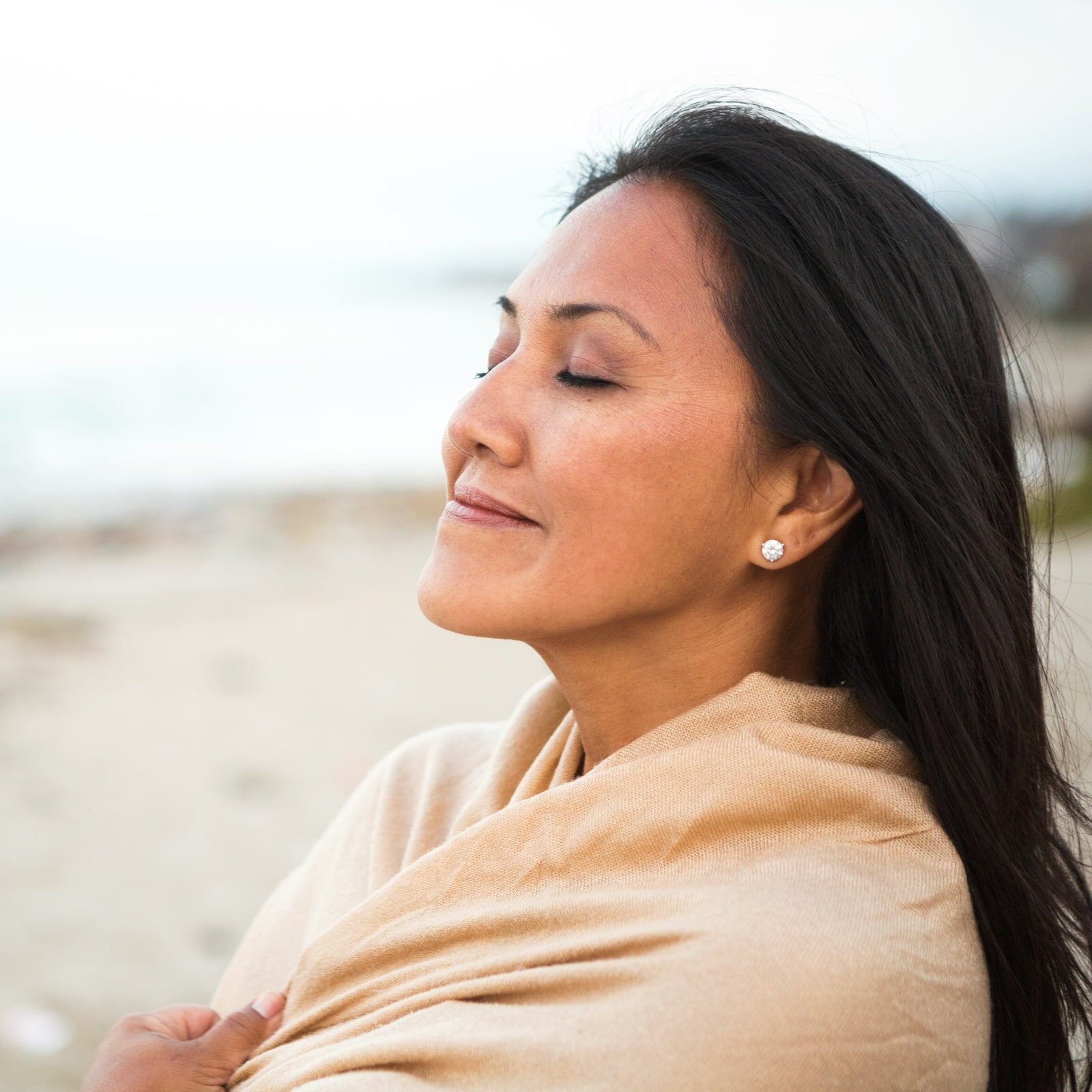 Beautiful confident Asian woman standing on the beach.