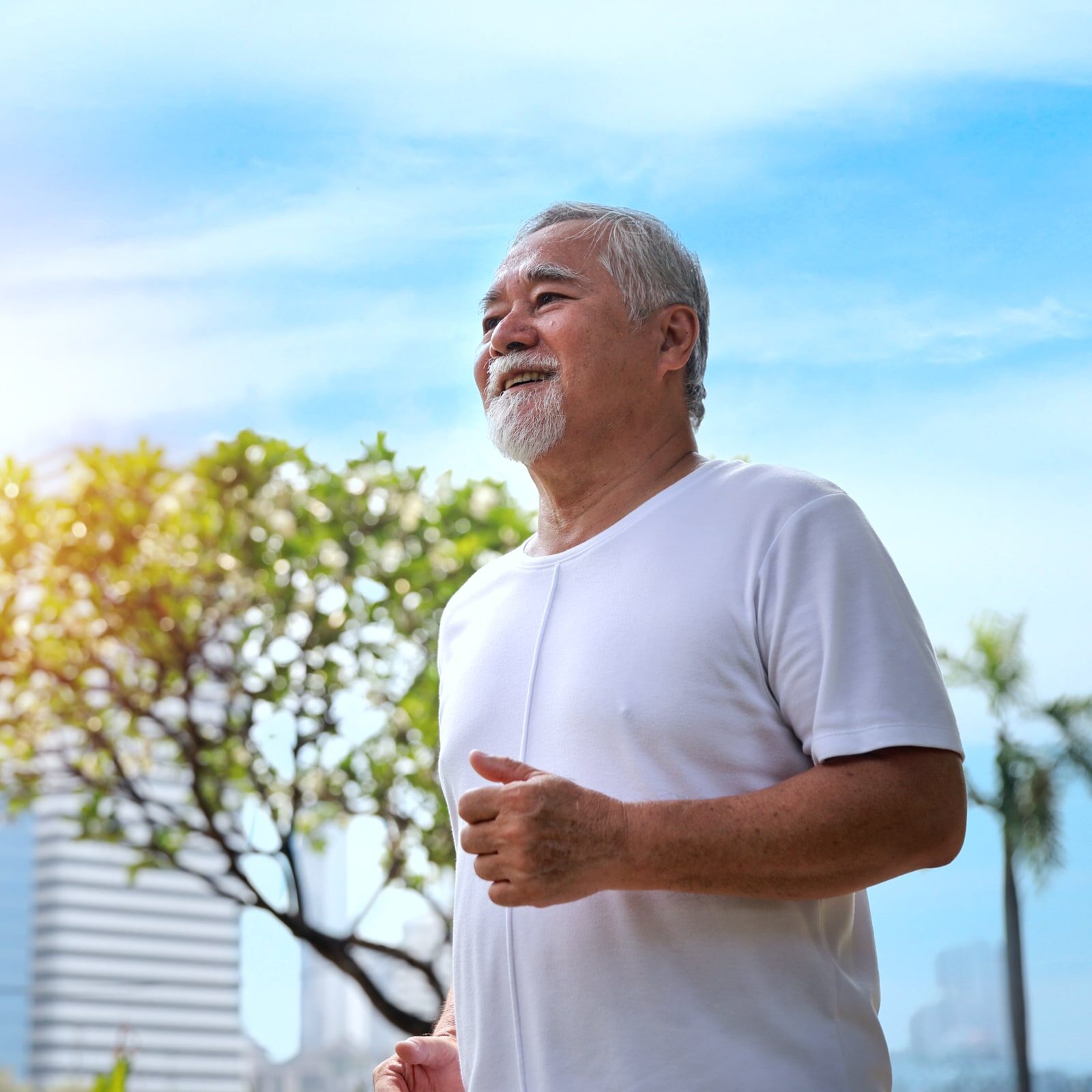 Happy and smiling senior man doing exercise and jogging