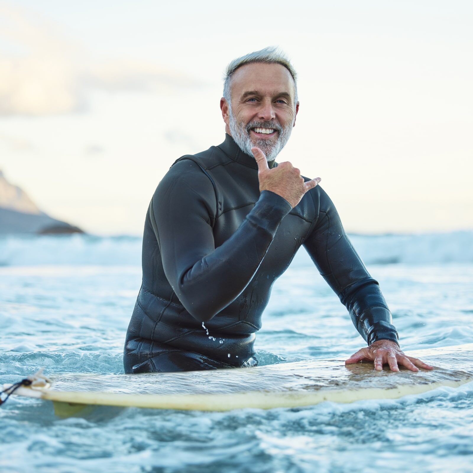 Senior man surfing in Hawaii beach