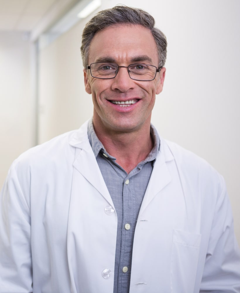 smiling Doctor standing at lobby in clinic