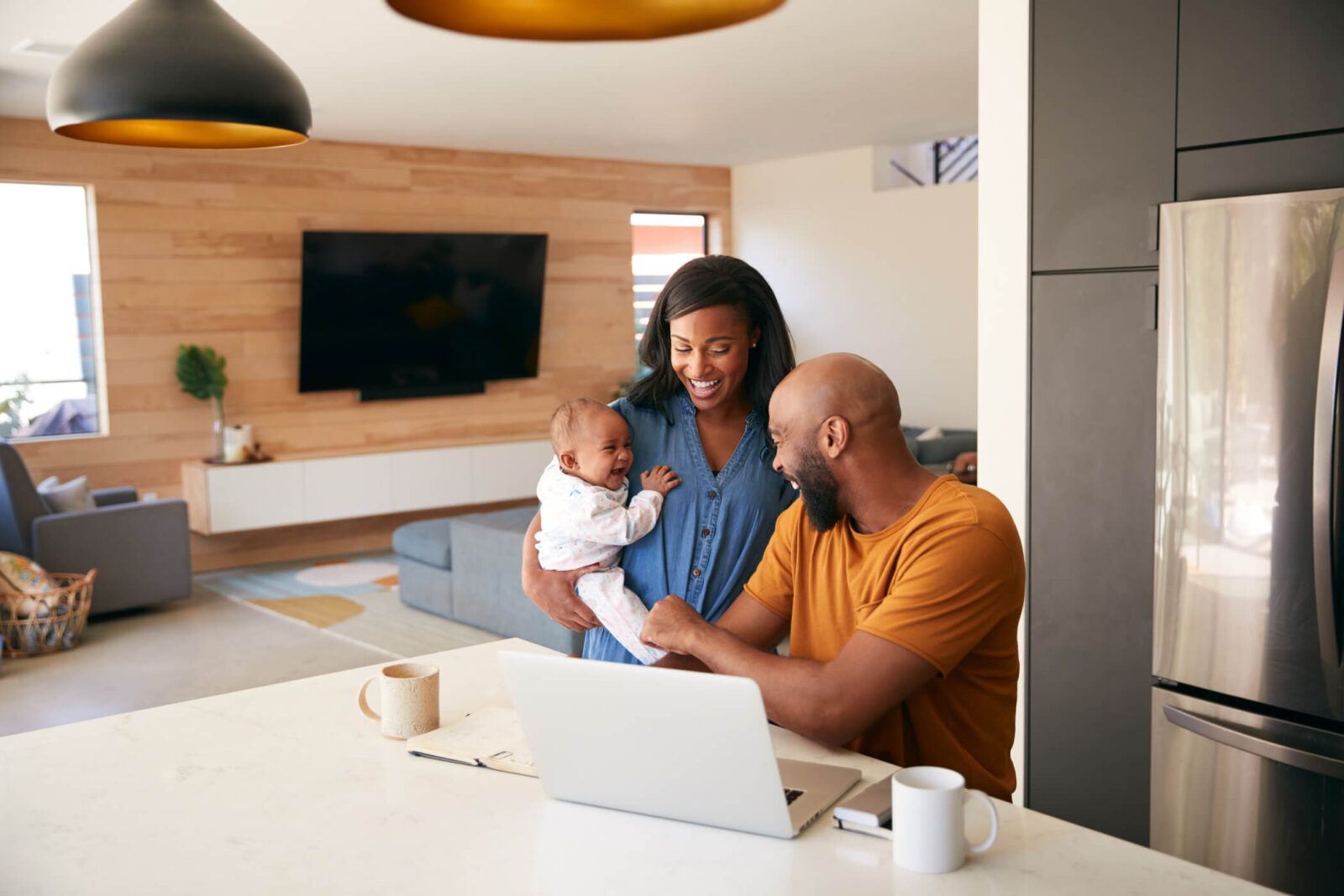 African American Family With Baby Daughter Using Laptop