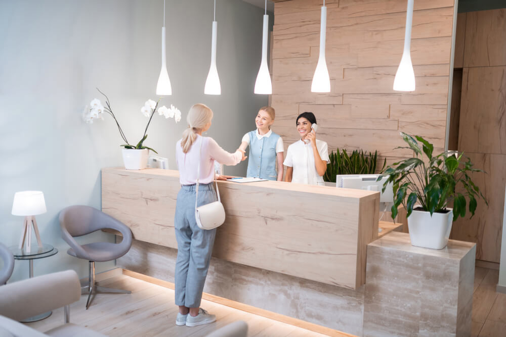 Woman standing at the reception of dental clinic