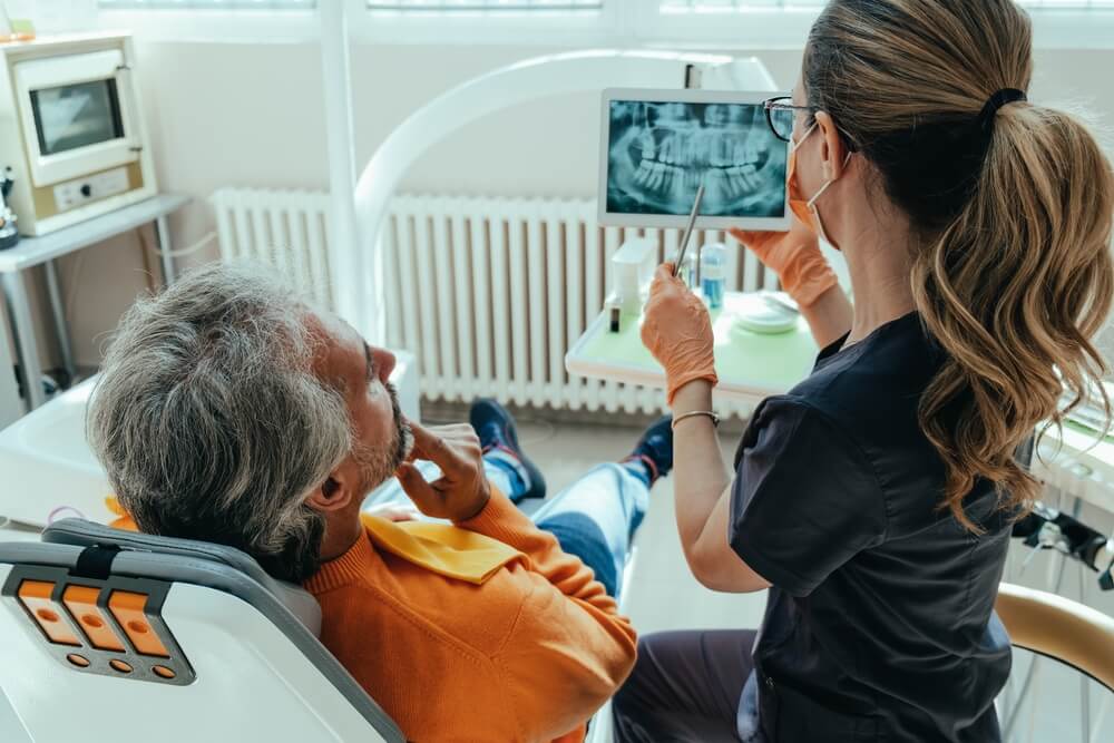 Unrecognizable Female Dentist Explaining Teeth X-ray