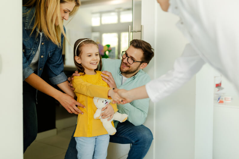 Parents and child girl in meeting with doctor orthodontist,