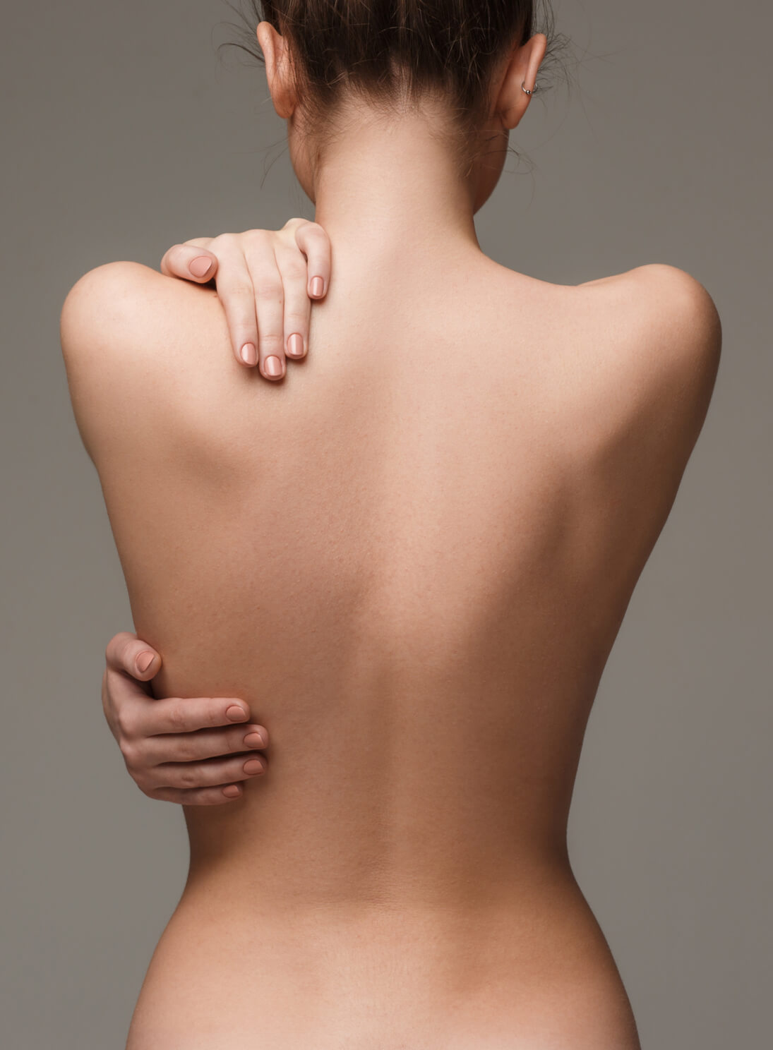 The beautiful woman's body on gray background