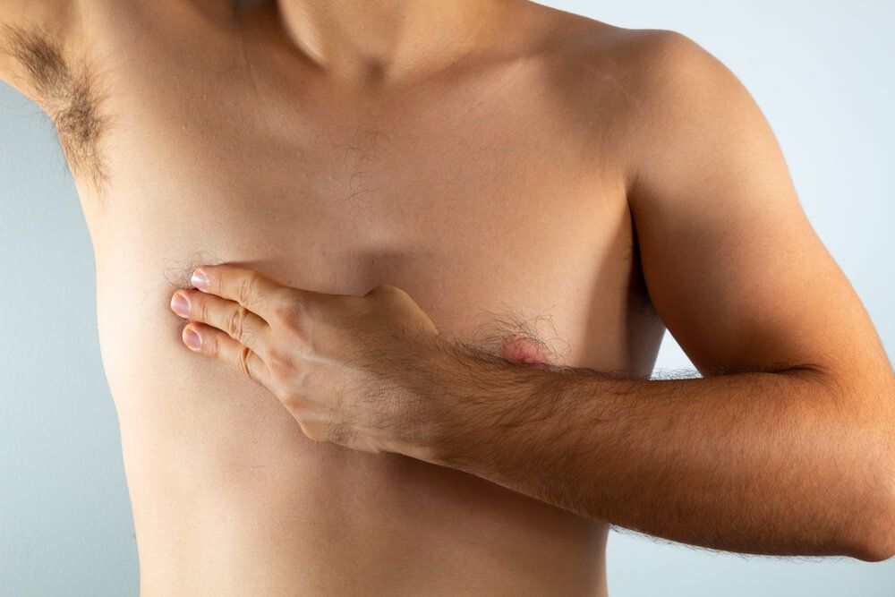 close up of a man's chest looking for signs of male breast cancer