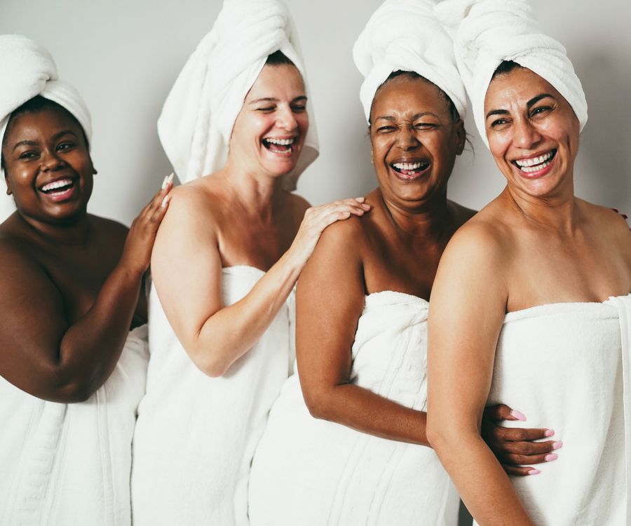 Multigeneration women with diverse skin and body laughing together