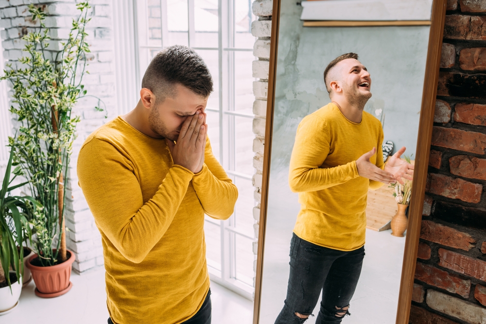 A man with bipolar disorder at the mirror.