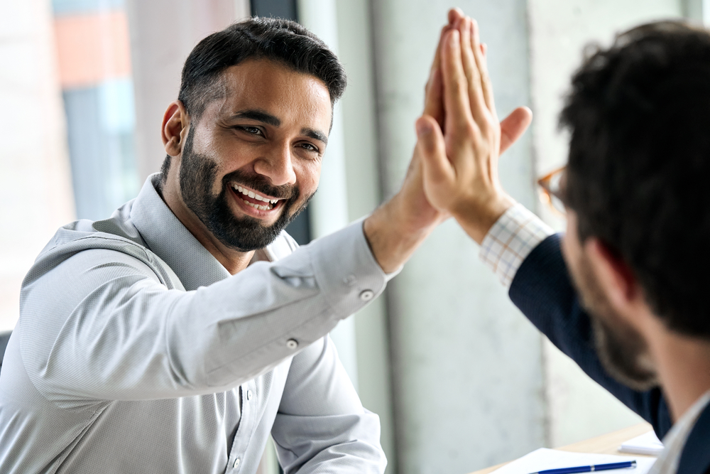 happy smiling professional man giving high-five