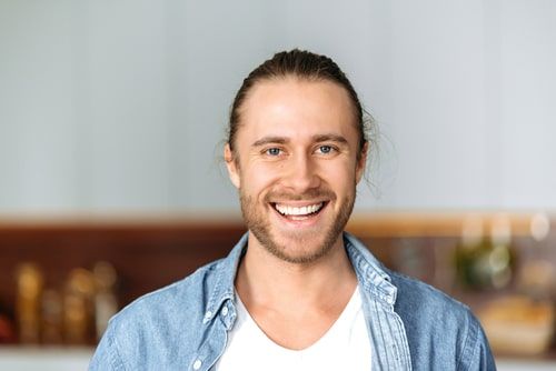Young man smiling and looking at camera
