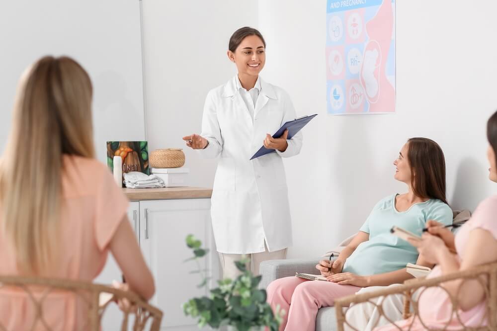 Female doctor with expectant mothers at course