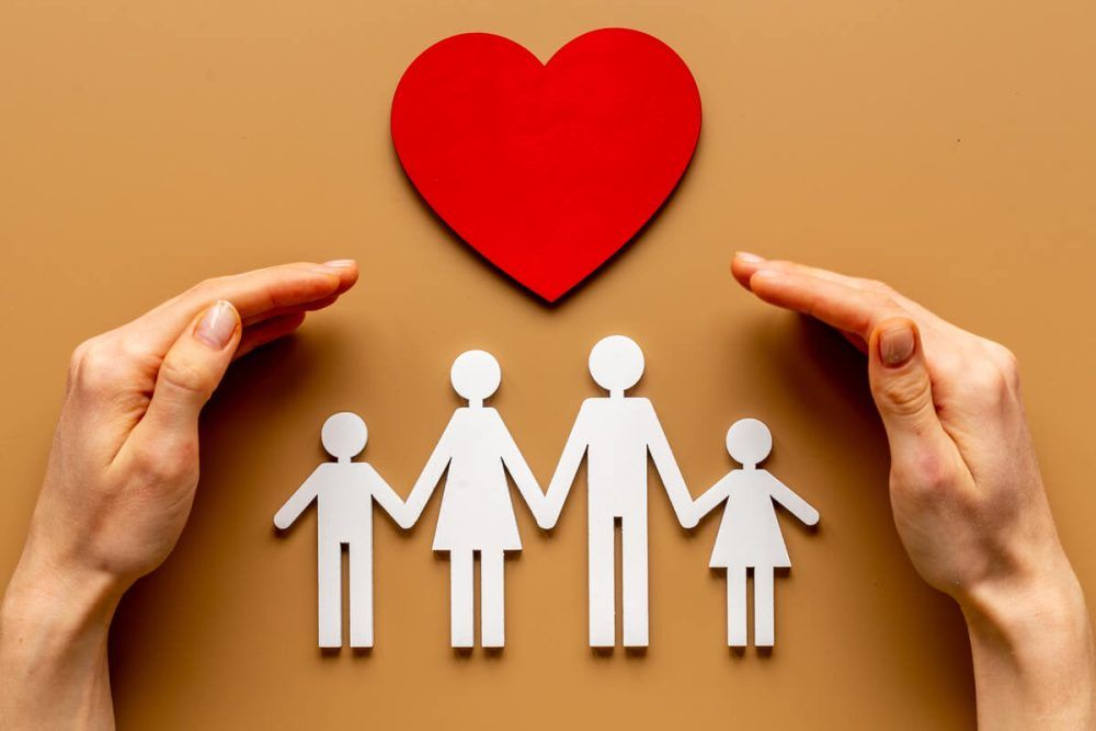 Hands holding family figure