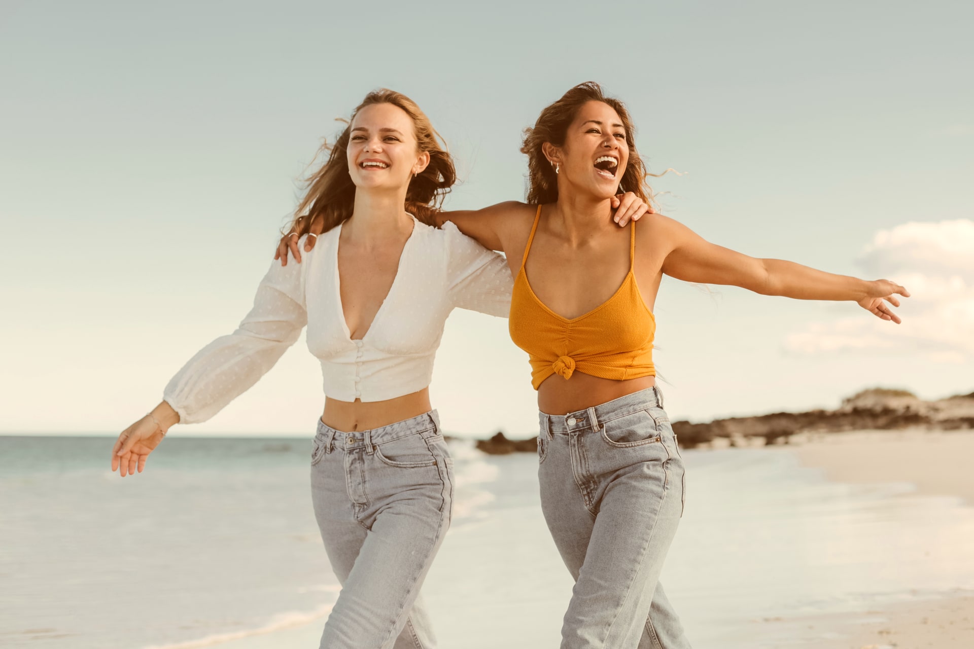 Two women walking together at the beach