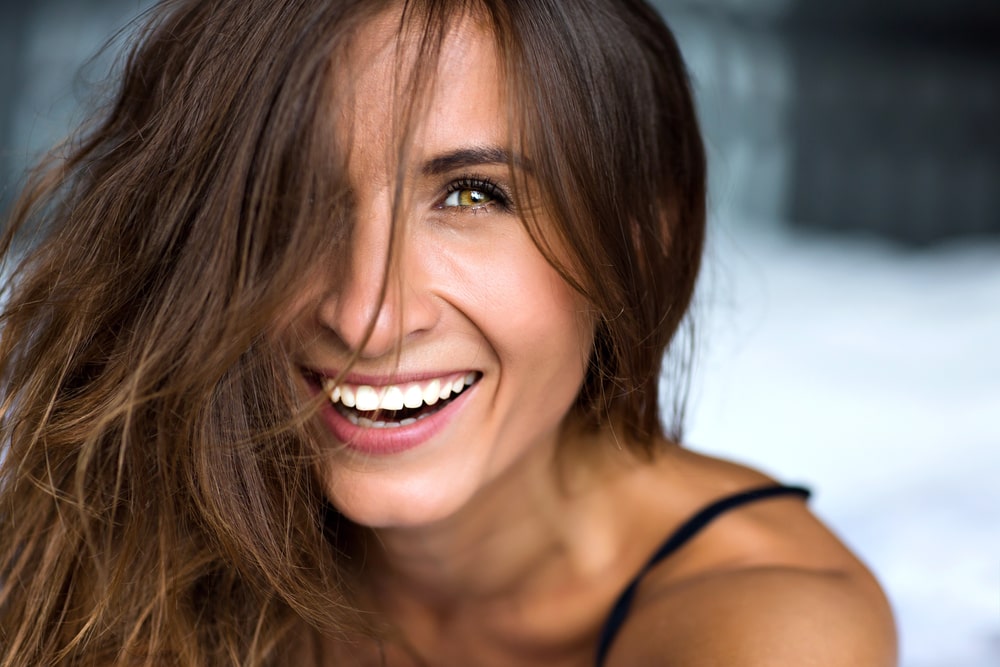 Close up morning portrait of smiling pretty woman with green eyes