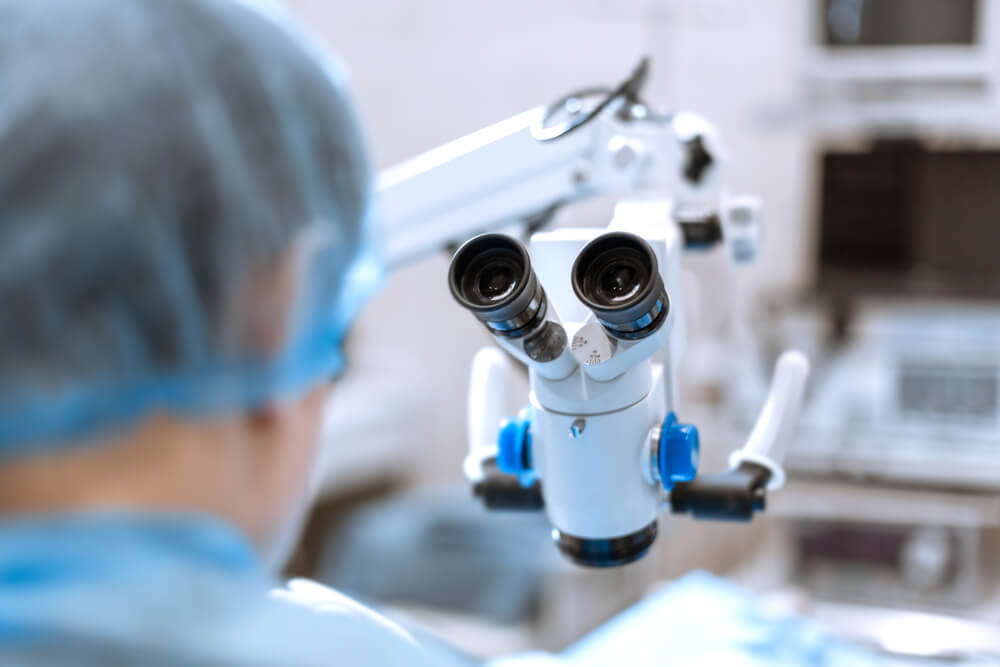 surgeon in front of surgical microscope prepare to hard operation.