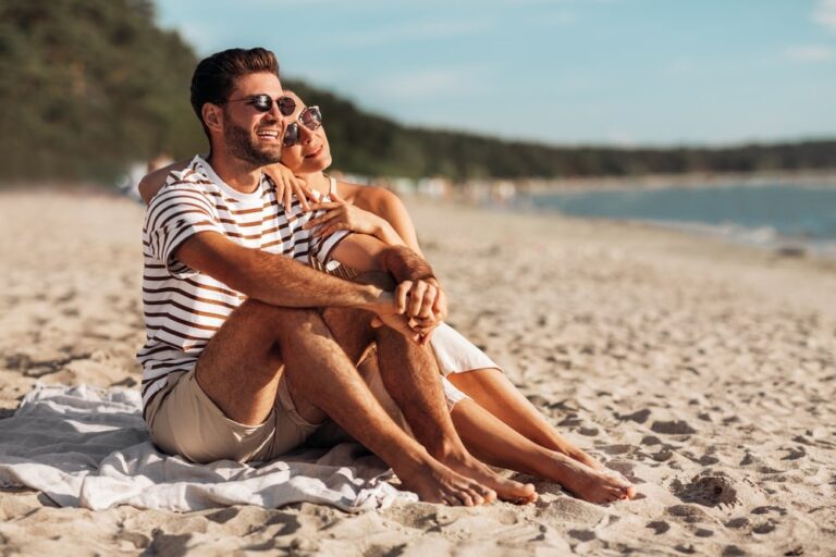 happy smiling couple chilling on beach