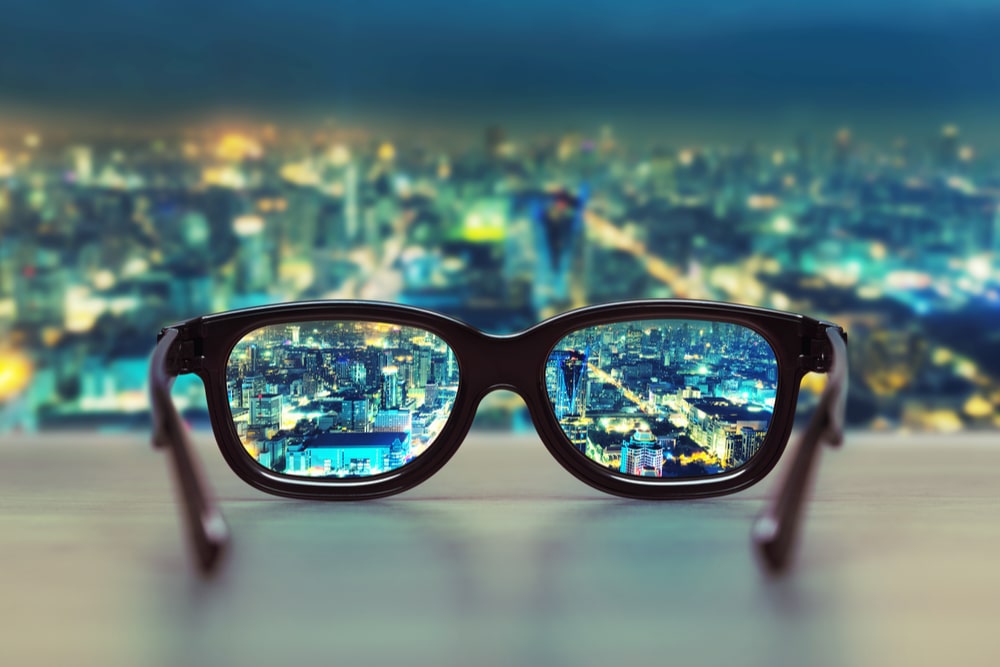 Night cityscape focused in glasses lenses