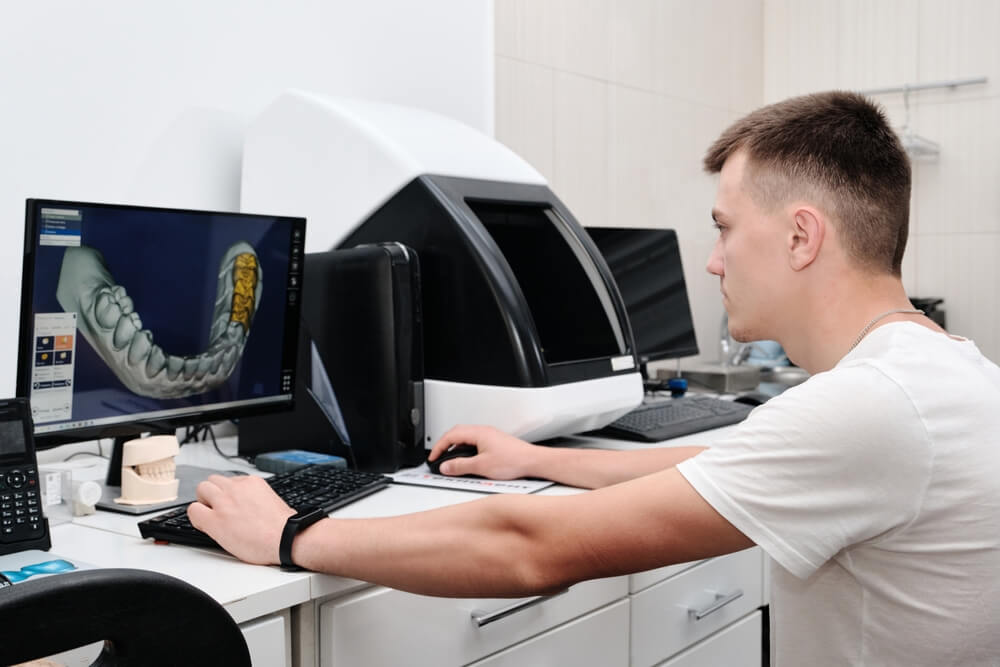 Dental technician working with a computer in a laboratory