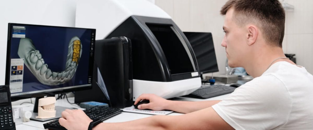 Dental technician working with a computer in a laboratory