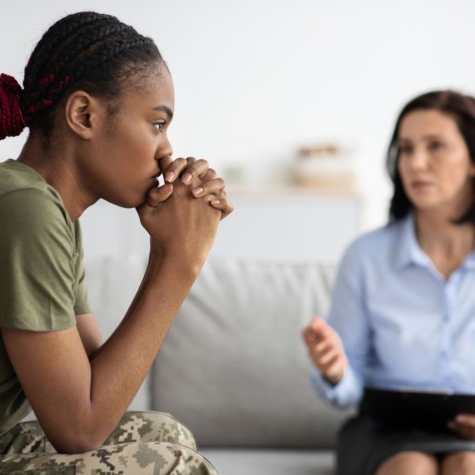 Upset Pensive Black Military Lady Having Therapy Session With Psychologist In Office