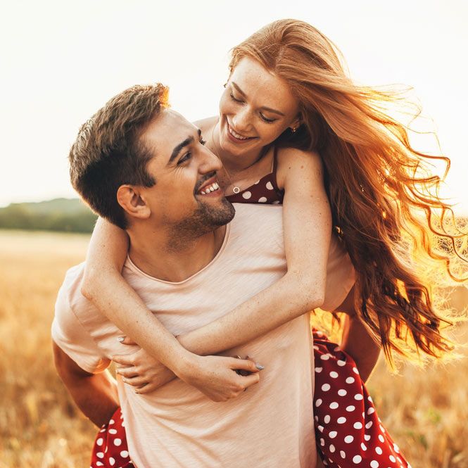 couple man carrying on back redhead lover anjoying sunlight weekend vacation