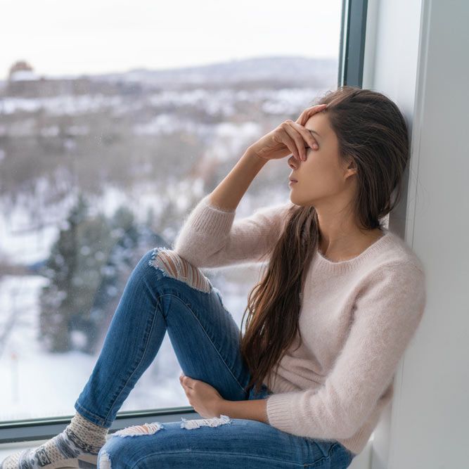 Seasonal affective disorder SAD depression winter season anxious alone young girl feeling lonely - stress, anxiety, melancholy emotion at home. Mental health problem.
