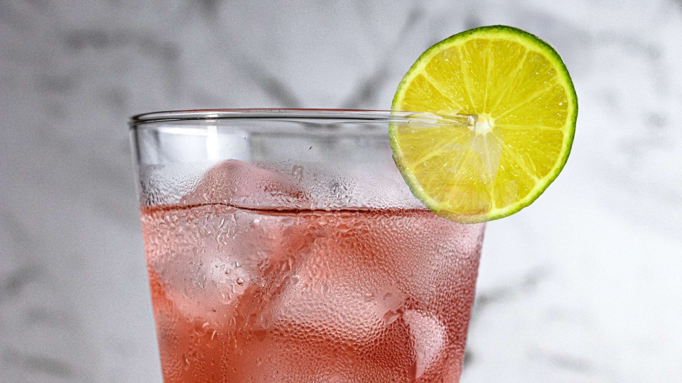 Glass of red fruit punch with lemon