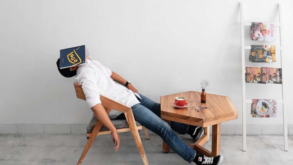 Man in casual wear lying on chair