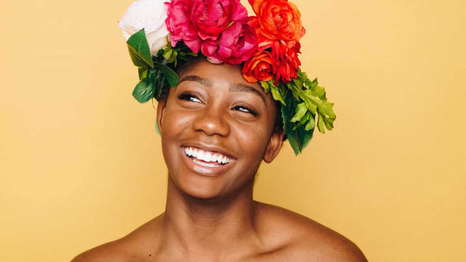 Young black woman with afro and sunflowers