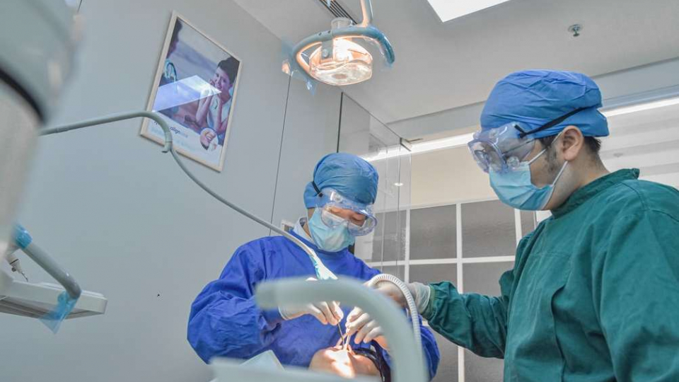 two veterinarian surgeons in operating room