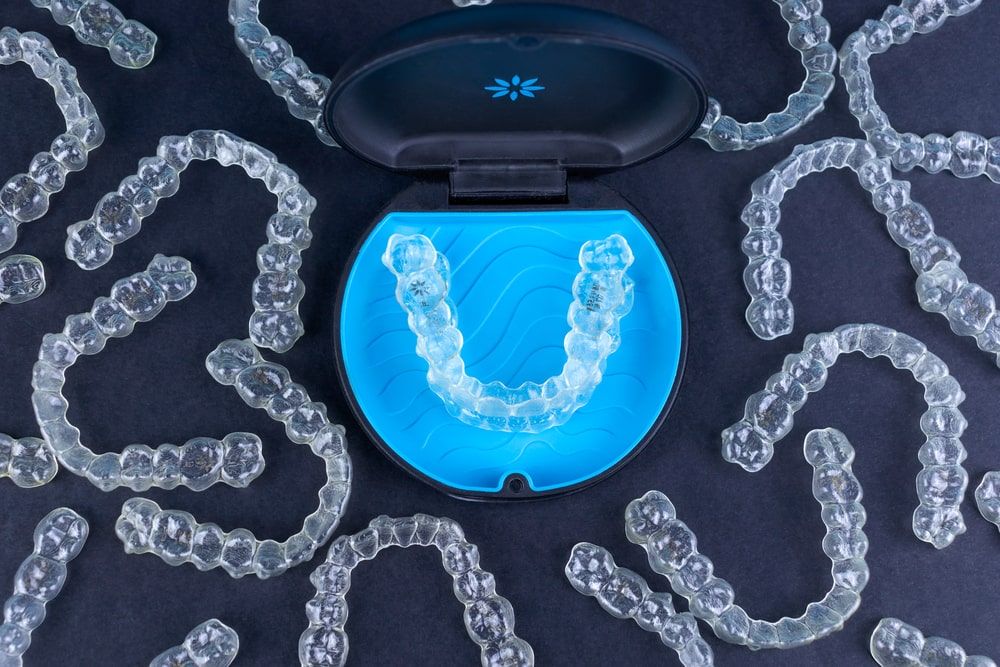 Plastic case with invisible transparent orthodontic retainers invisalign