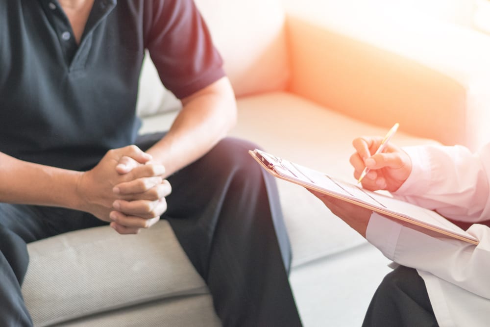 Male Patient Sitting with doctor