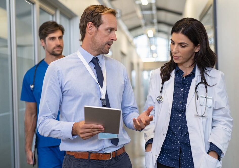 Man and woman doctor having a discussion in hospital hallway