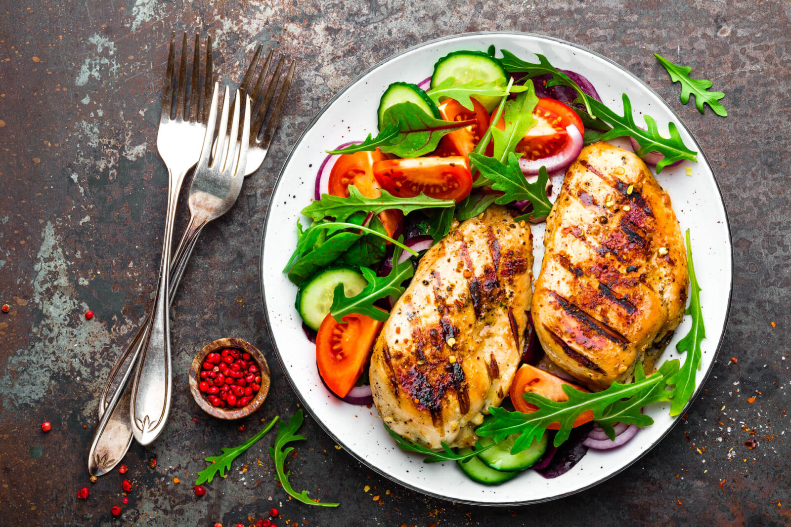 Grilled chicken breast. Fried chicken fillet and fresh vegetable salad of tomatoes