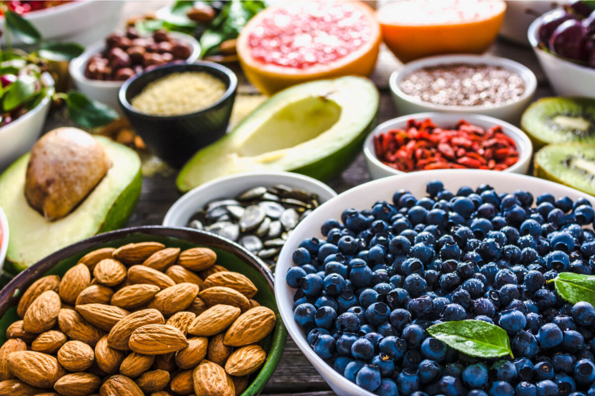 Bowl with almonds, bilberry, fresh fruit and other healthy food