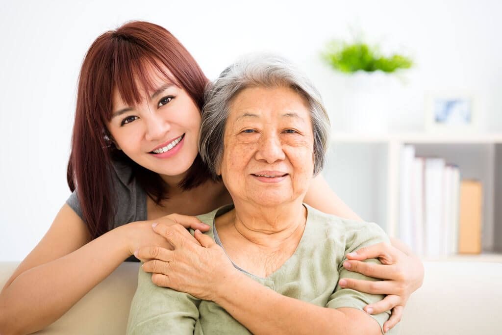 oung woman carefully takes care of old woman