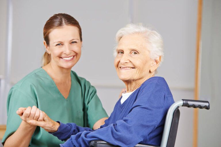 Geriatric nurse and senior woman in wheelchair