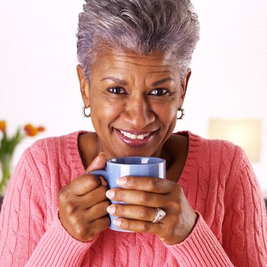Mature woman smiling with coffee mug
