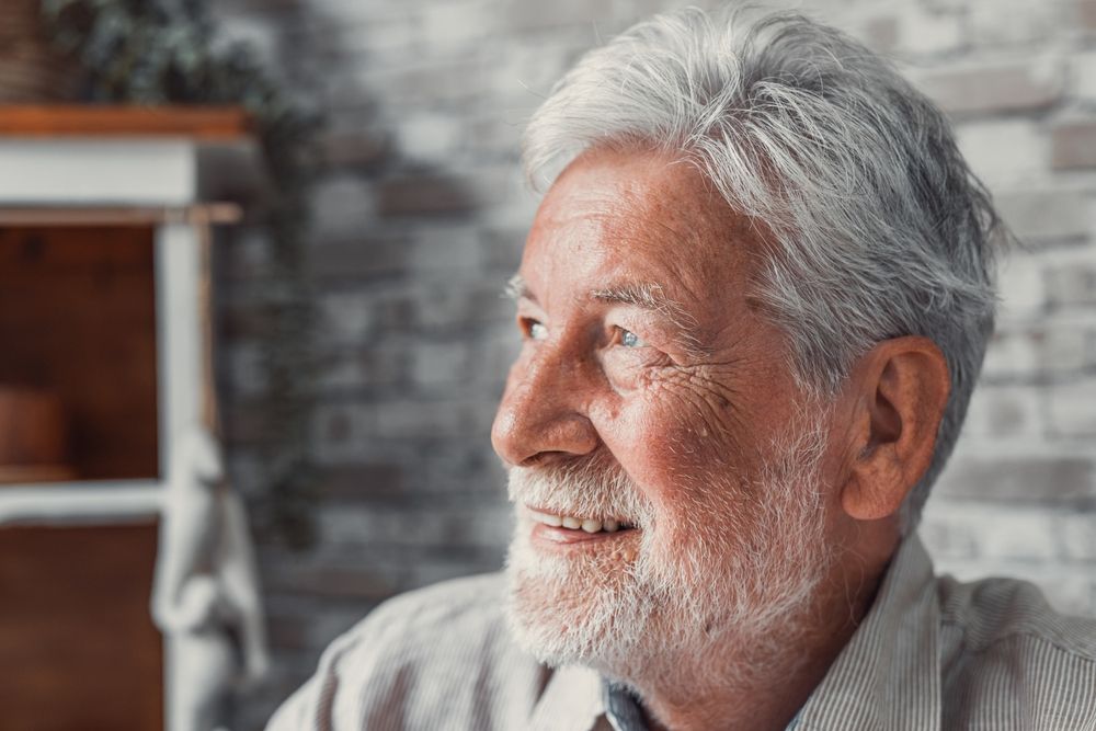 A man with Alzheimer's looking away from the camera