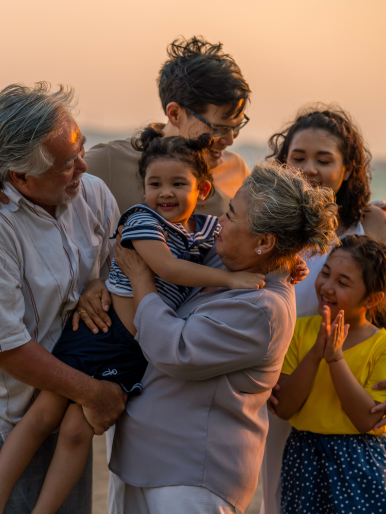 Happy big Asian family on beach holiday vacation