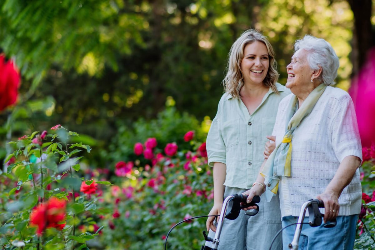 Adult granddaguhter supporting her senior grandmother