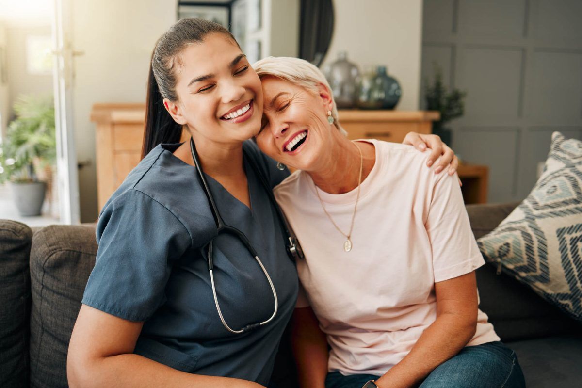 Senior woman, hug or medical caregiver in house living room in comfort trust