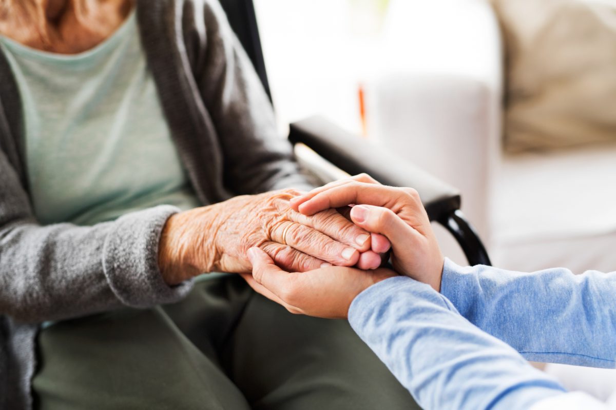 Unrecognizable health visitor and a senior woman