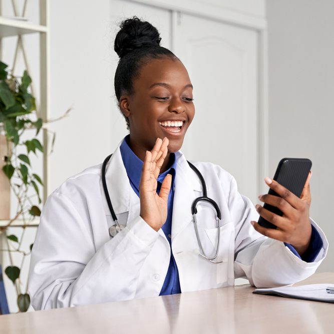 Female doctor holding phone talk to patient make telemedicine online video call